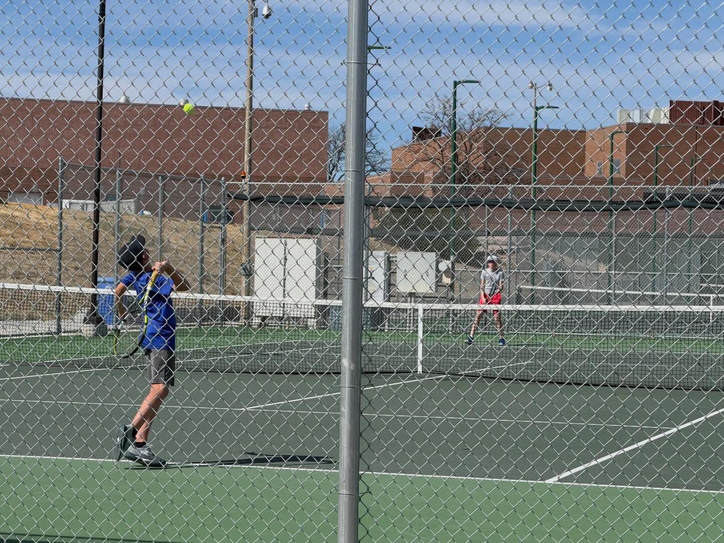 Junior player hitting on an outdoor court