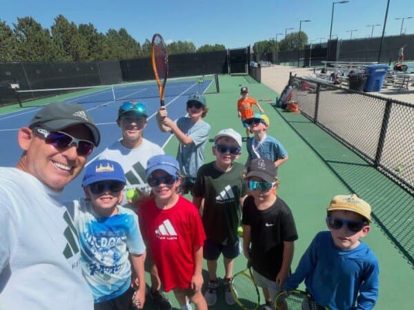 Coach Steve with a group of campers at the adidas Tennis Camp at CSU